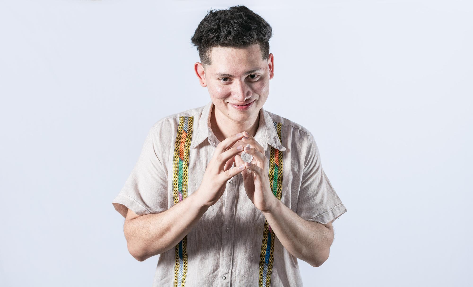 artisan smiling while holding embroidered garment